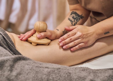 Massage therapy at Fina, B kara, MT, promotes relaxation with wooden massager technique.