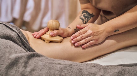 Massage therapy at Fina, B kara, MT, promotes relaxation with wooden massager technique.