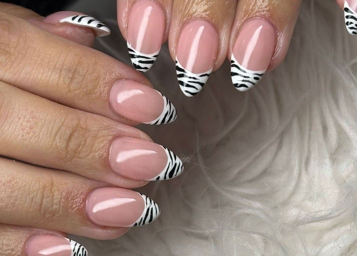 Stylish zebra pattern nails from Fina in B kara, MT, showcasing intricate nail art design.