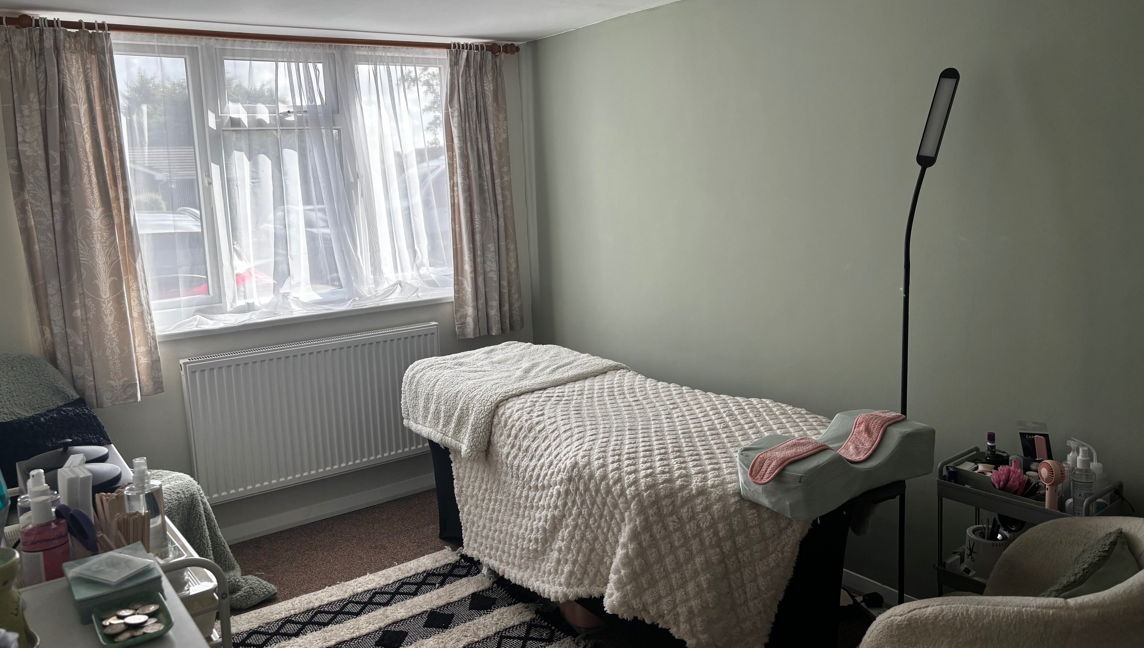 Cozy therapy room at Megan Ellen Beauty in Rushmere Saint Andrew, England, GB, featuring a treatment bed.