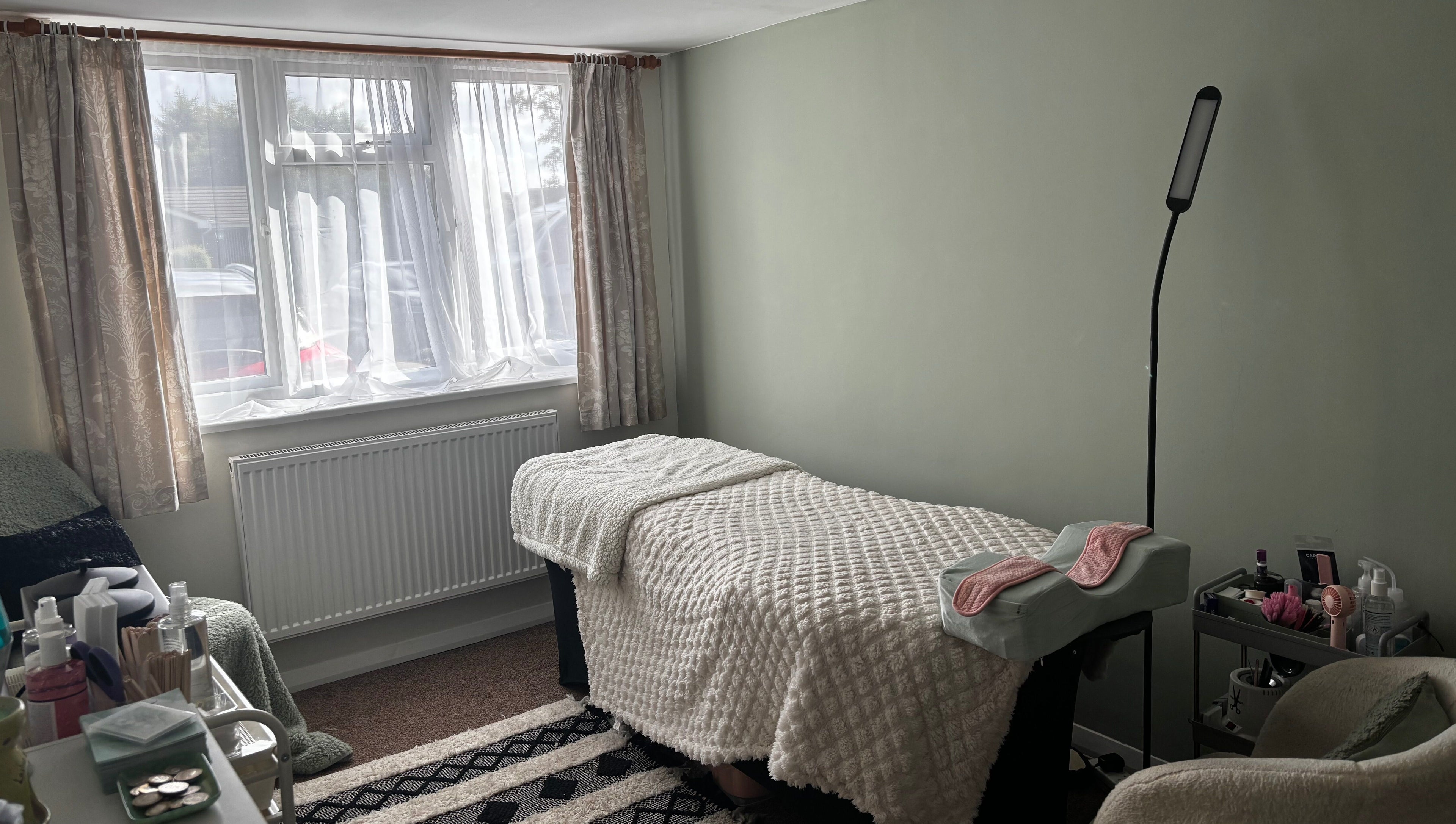 Cozy therapy room at Megan Ellen Beauty in Rushmere Saint Andrew, England, GB, featuring a treatment bed.