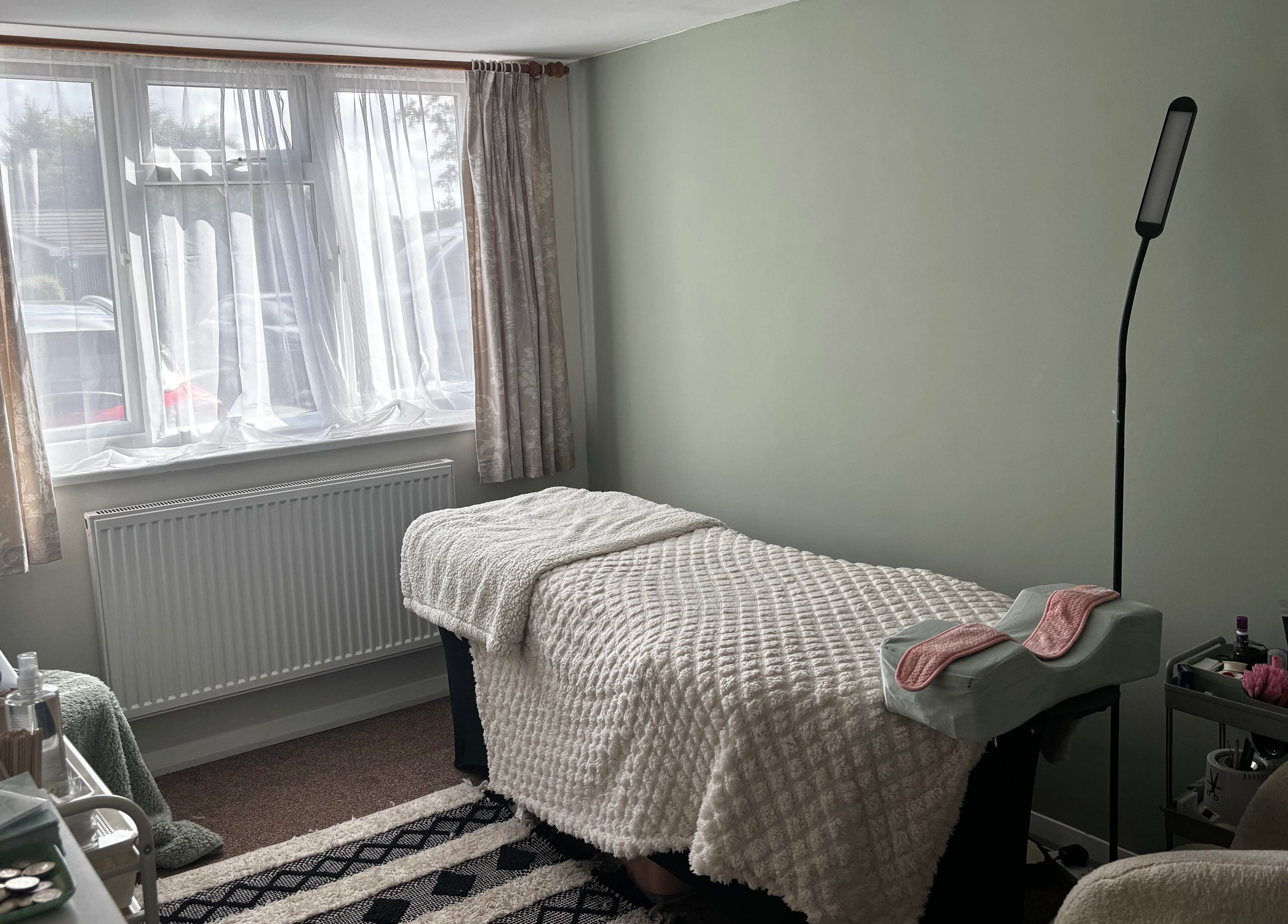 Cozy therapy room at Megan Ellen Beauty in Rushmere Saint Andrew, England, GB, featuring a treatment bed.