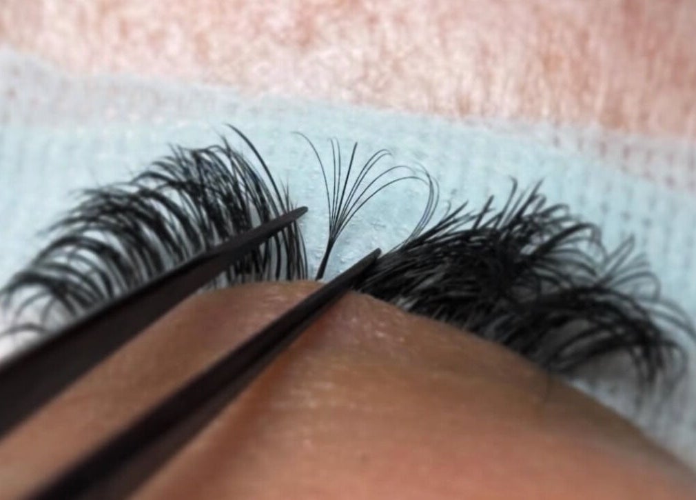 Close-up of eyelash extension application at Megan Ellen Beauty, Rushmere Saint Andrew, England, GB.