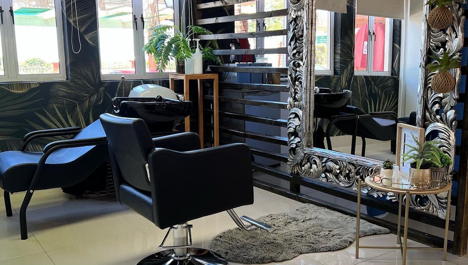 Stylish salon interior at Durban Designer Brows SA, Umhlanga, Kwazulu-natal, ZA with ornate mirror and plants.