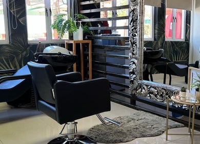 Stylish salon interior at Durban Designer Brows SA, Umhlanga, Kwazulu-natal, ZA with ornate mirror and plants.