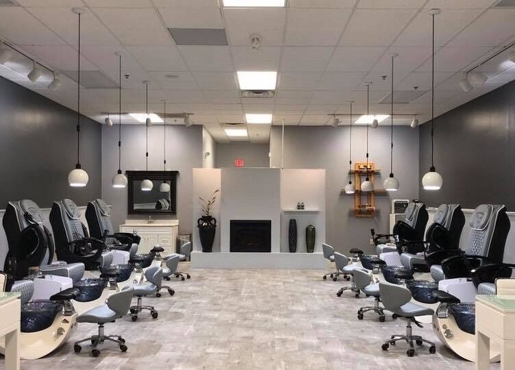 Spacious pedicure area at Elysian Nails in Neenah, Wisconsin, US with modern chairs and ambient lighting.
