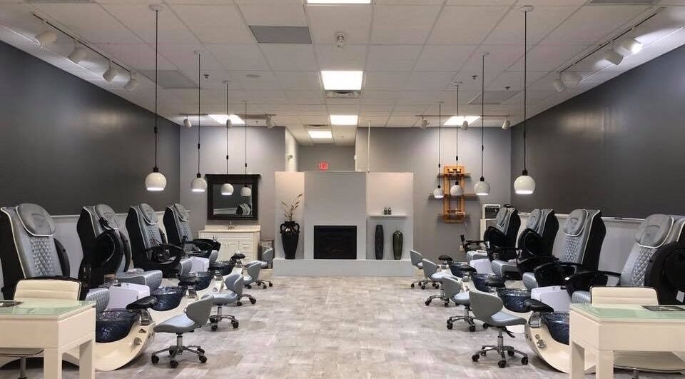 Spacious pedicure area at Elysian Nails in Neenah, Wisconsin, US with modern chairs and ambient lighting.