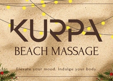 Kurpa Beach Massage signage with festive lights in Willemstad, CW.