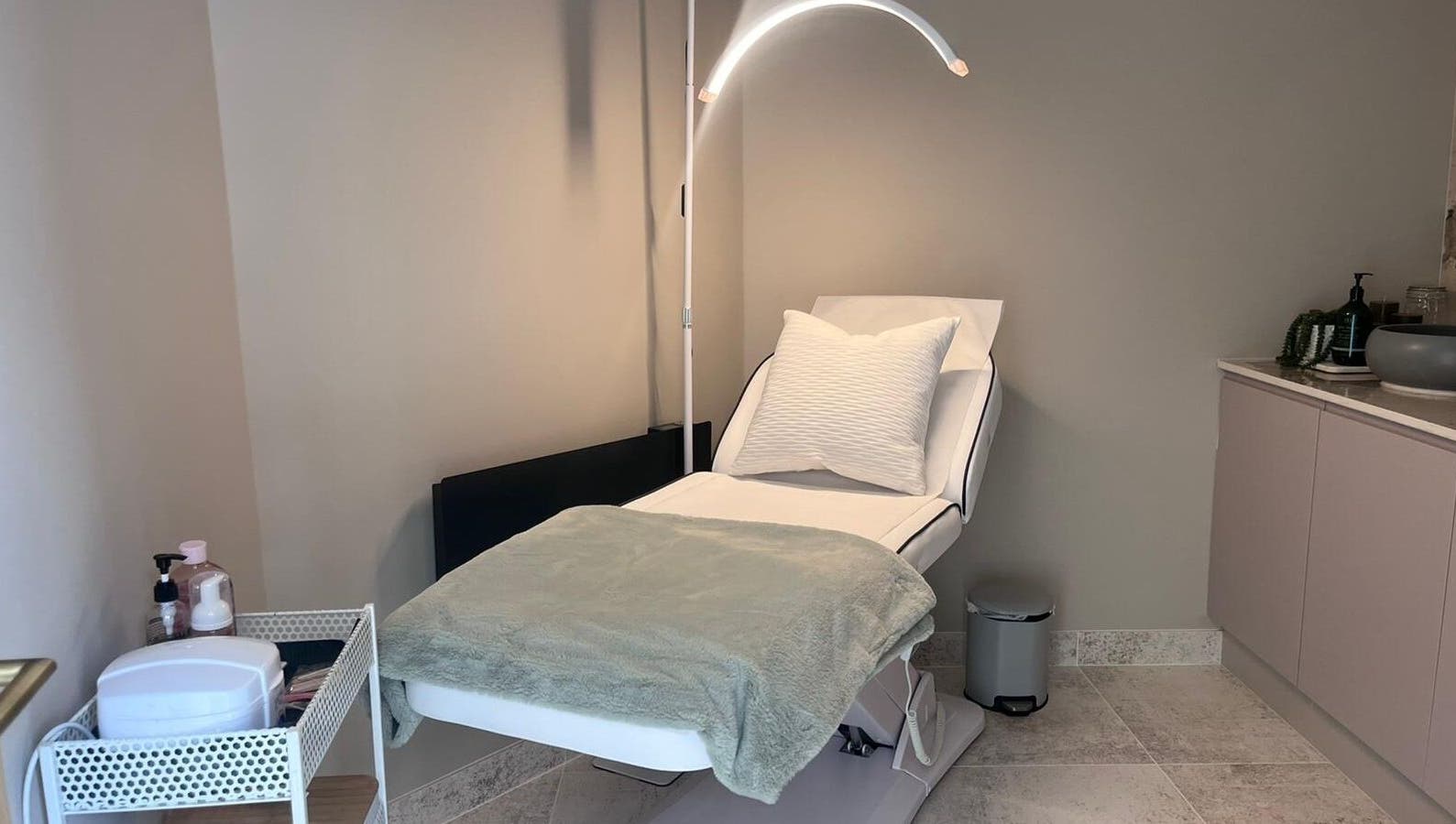 Tranquil treatment room at Thoroughbred Brows, Newmarket, England, GB featuring a comfortable reclining chair.