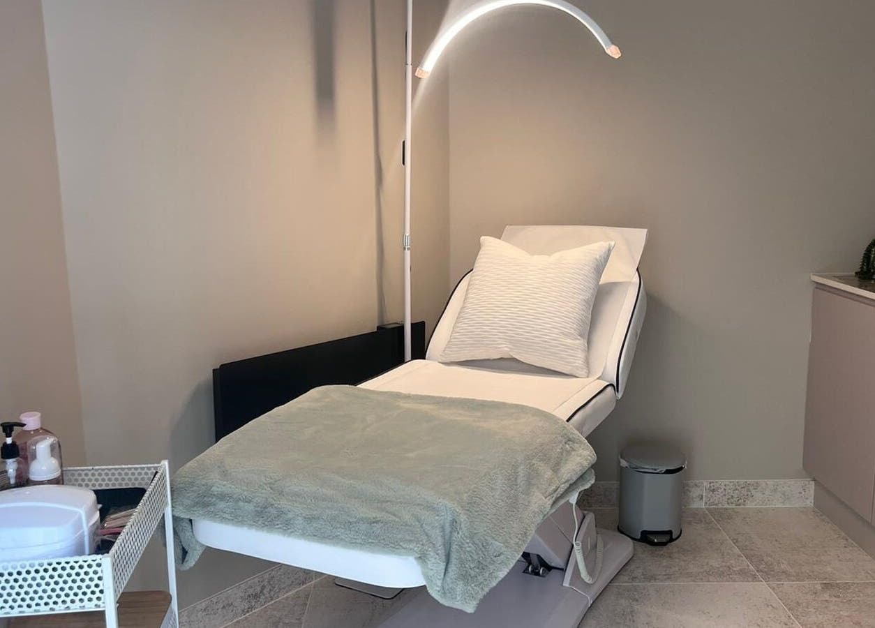 Tranquil treatment room at Thoroughbred Brows, Newmarket, England, GB featuring a comfortable reclining chair.