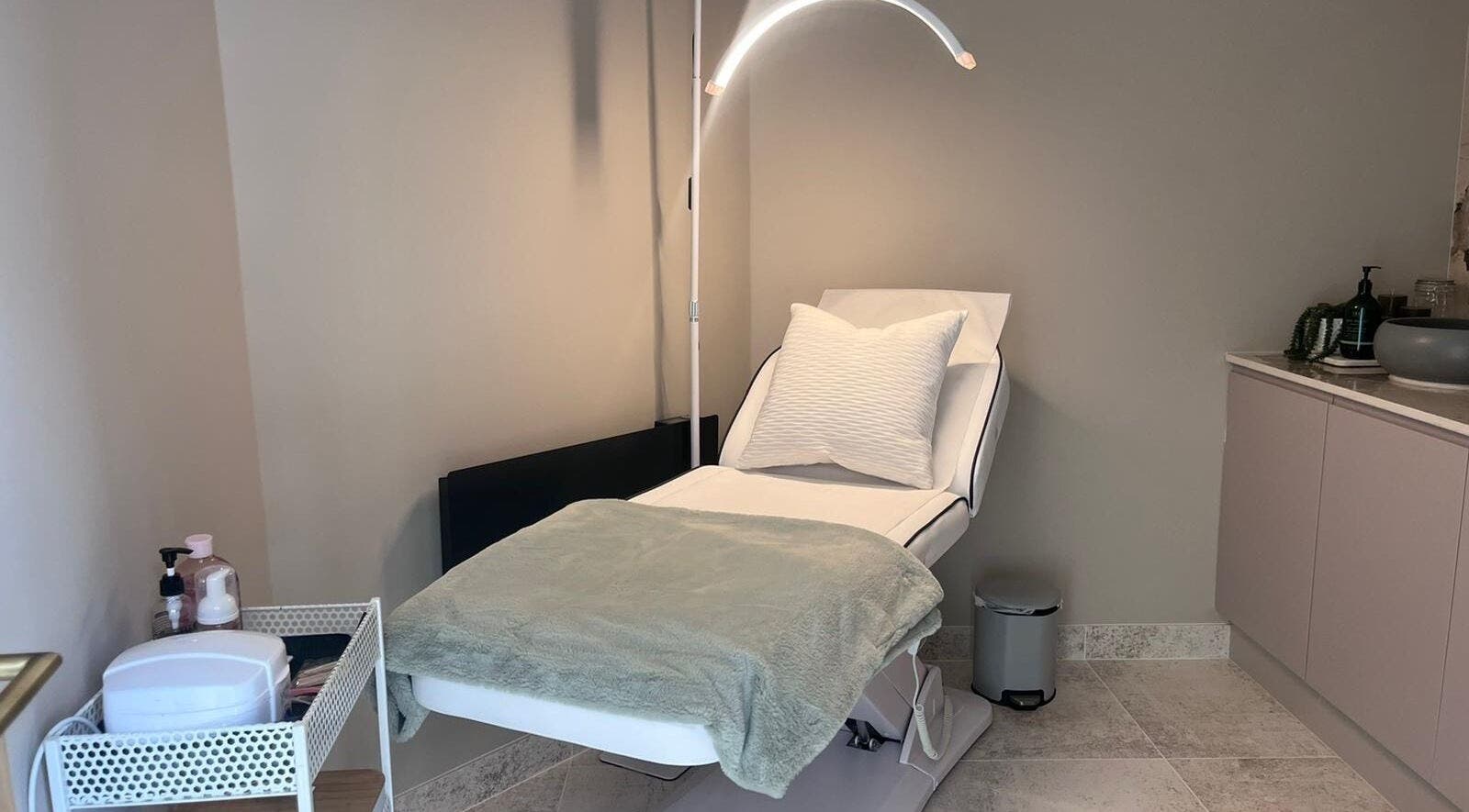 Tranquil treatment room at Thoroughbred Brows, Newmarket, England, GB featuring a comfortable reclining chair.