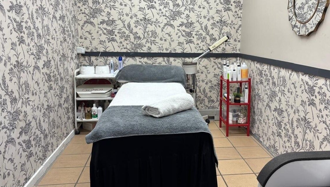 Cozy treatment room at Made up by Mariam in Hillcrest, Kwazulu-natal, ZA, featuring a spa bed and floral decor.