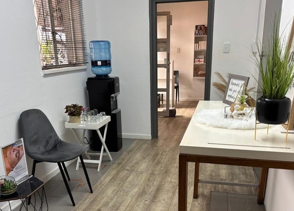 Relaxing waiting area at Made up by Mariam, Hillcrest, Kwazulu-natal, ZA with chairs, decor, and a water dispenser.