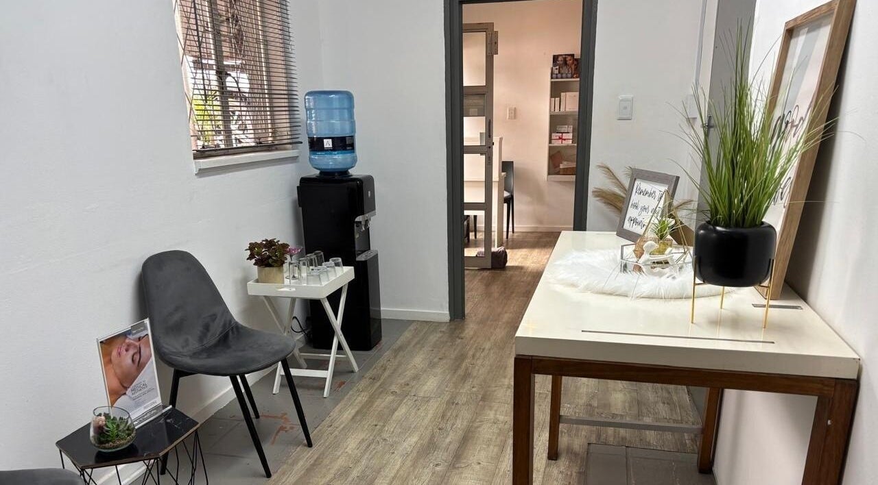 Relaxing waiting area at Made up by Mariam, Hillcrest, Kwazulu-natal, ZA with chairs, decor, and a water dispenser.