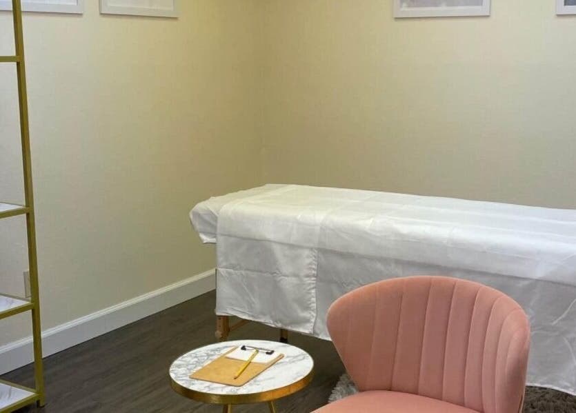 Elegant treatment room at K.R Brows and Beauty LLC, Arlington, Texas, US with a plush chair and treatment bed.