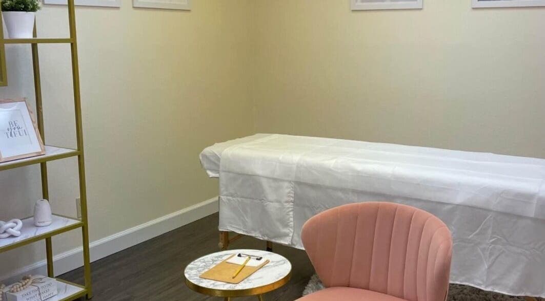 Elegant treatment room at K.R Brows and Beauty LLC, Arlington, Texas, US with a plush chair and treatment bed.