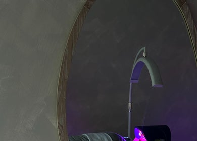 EVSSKIN's elegant and modern treatment room in San Fernando, California, US, with ambient lighting and plush decor.
