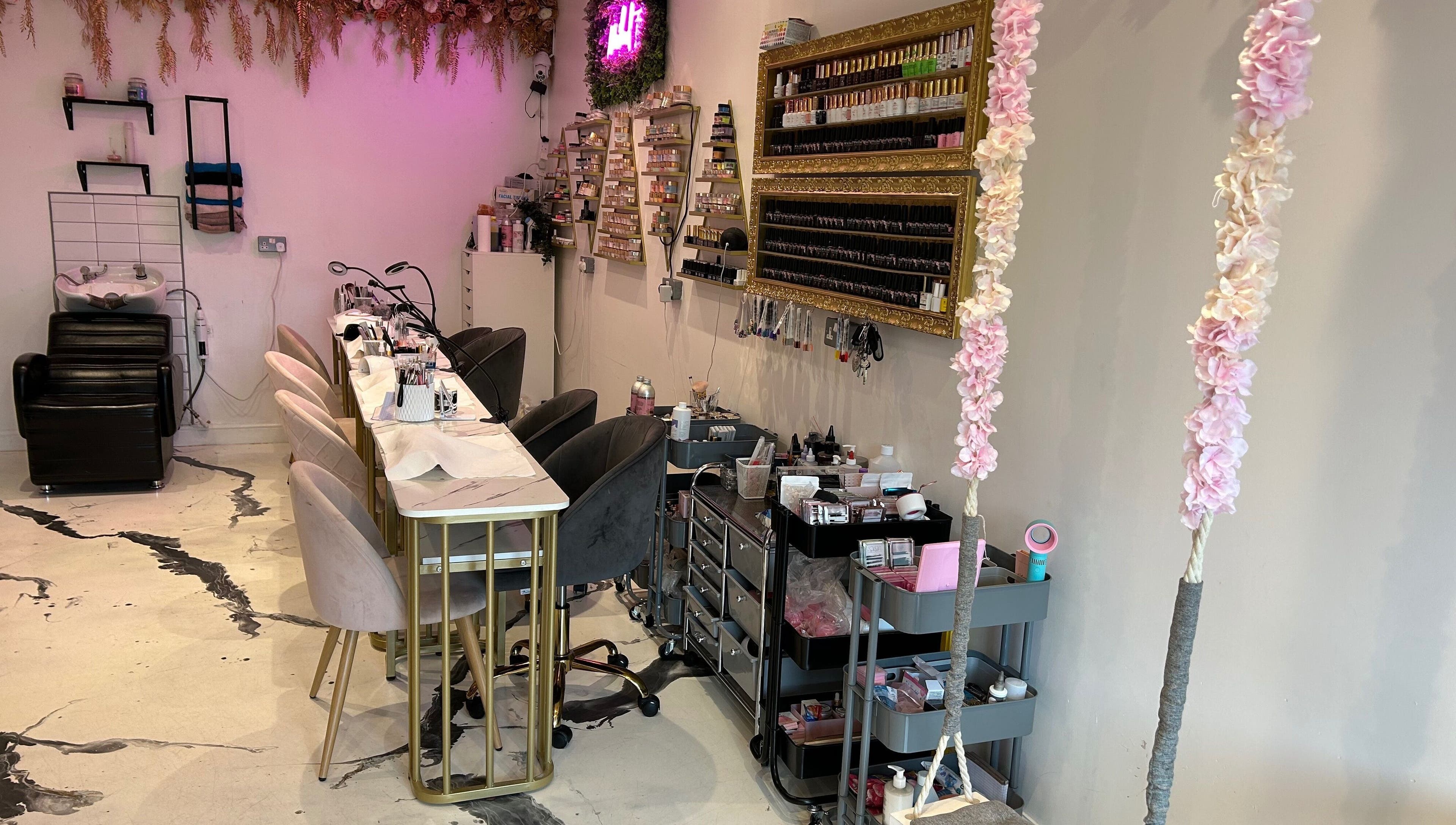 Elegant nail setup at The SAS Sanctuary and Academy, Stockport, England, GB, with stylish decor and seating.
