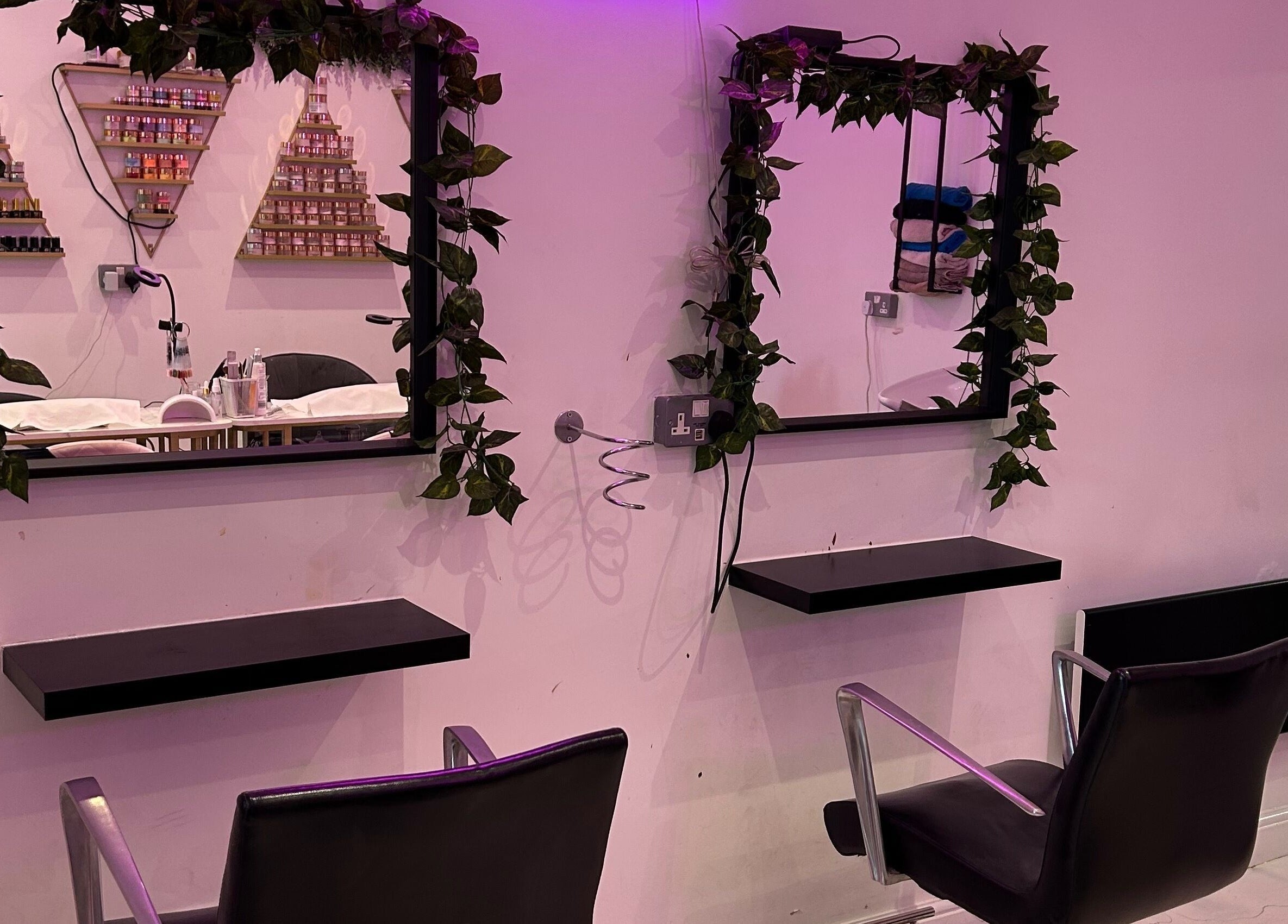 Elegant salon setup at The SAS Sanctuary and Academy, Stockport, England, GB with ivy-framed mirrors.