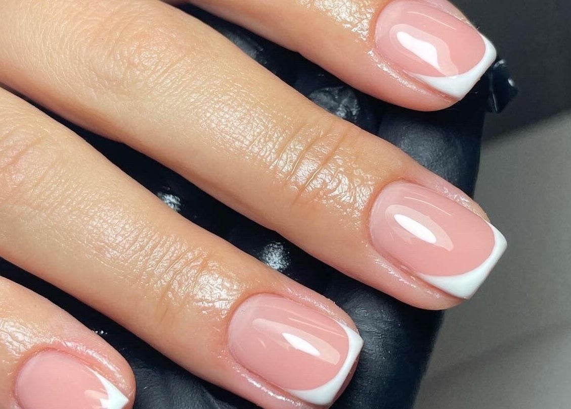 Elegant French manicure at Klbeauty, Runcorn, England, GB, showcasing glossy pink nails with white tips.