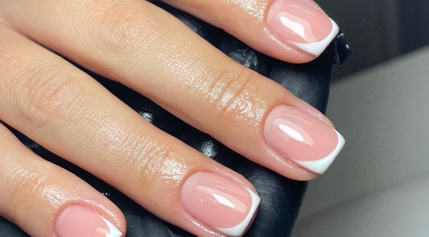 Elegant French manicure at Klbeauty, Runcorn, England, GB, showcasing glossy pink nails with white tips.