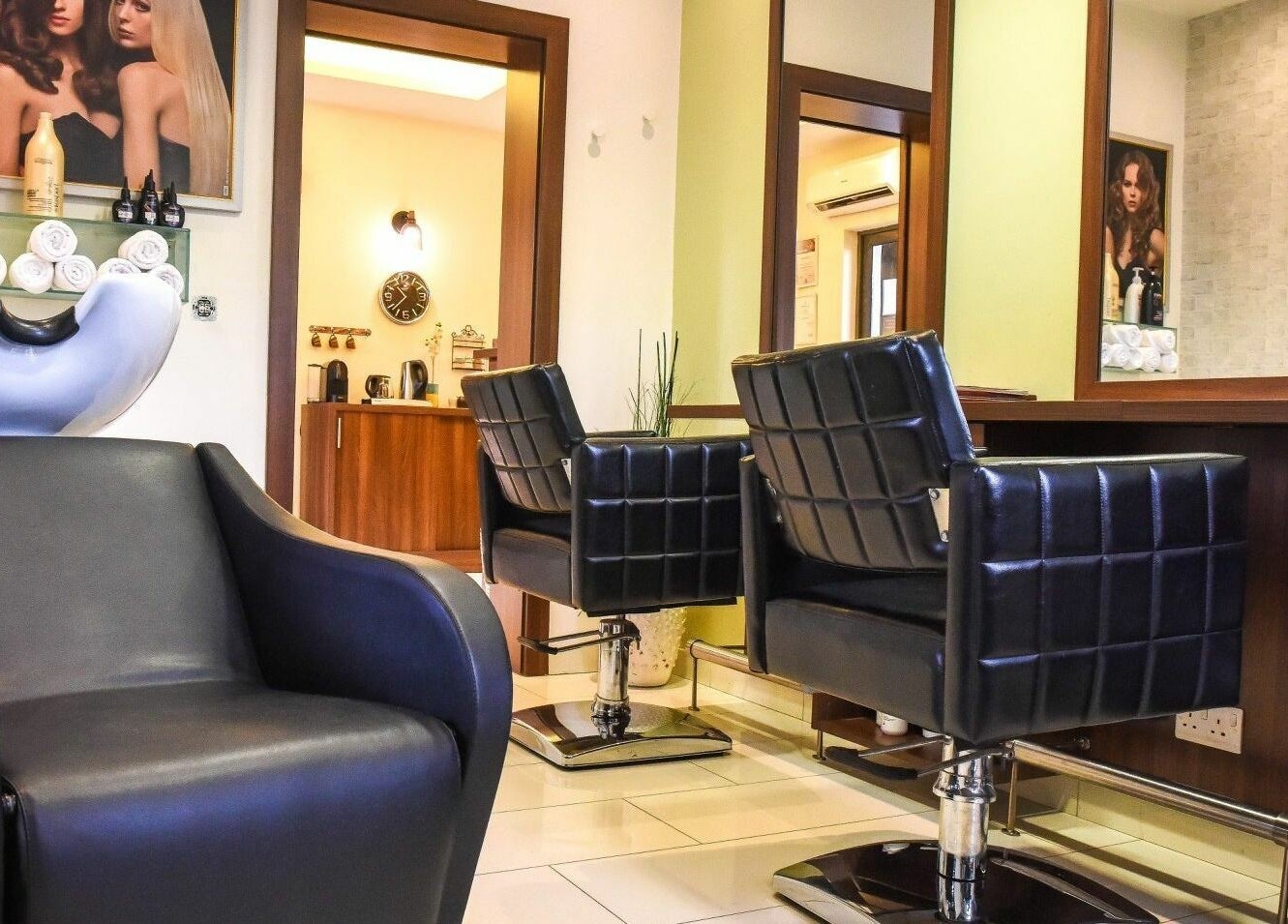 Modern salon interior at Beauty Addict, Abuja, Federal Capital Territory, NG, featuring stylish black chairs.