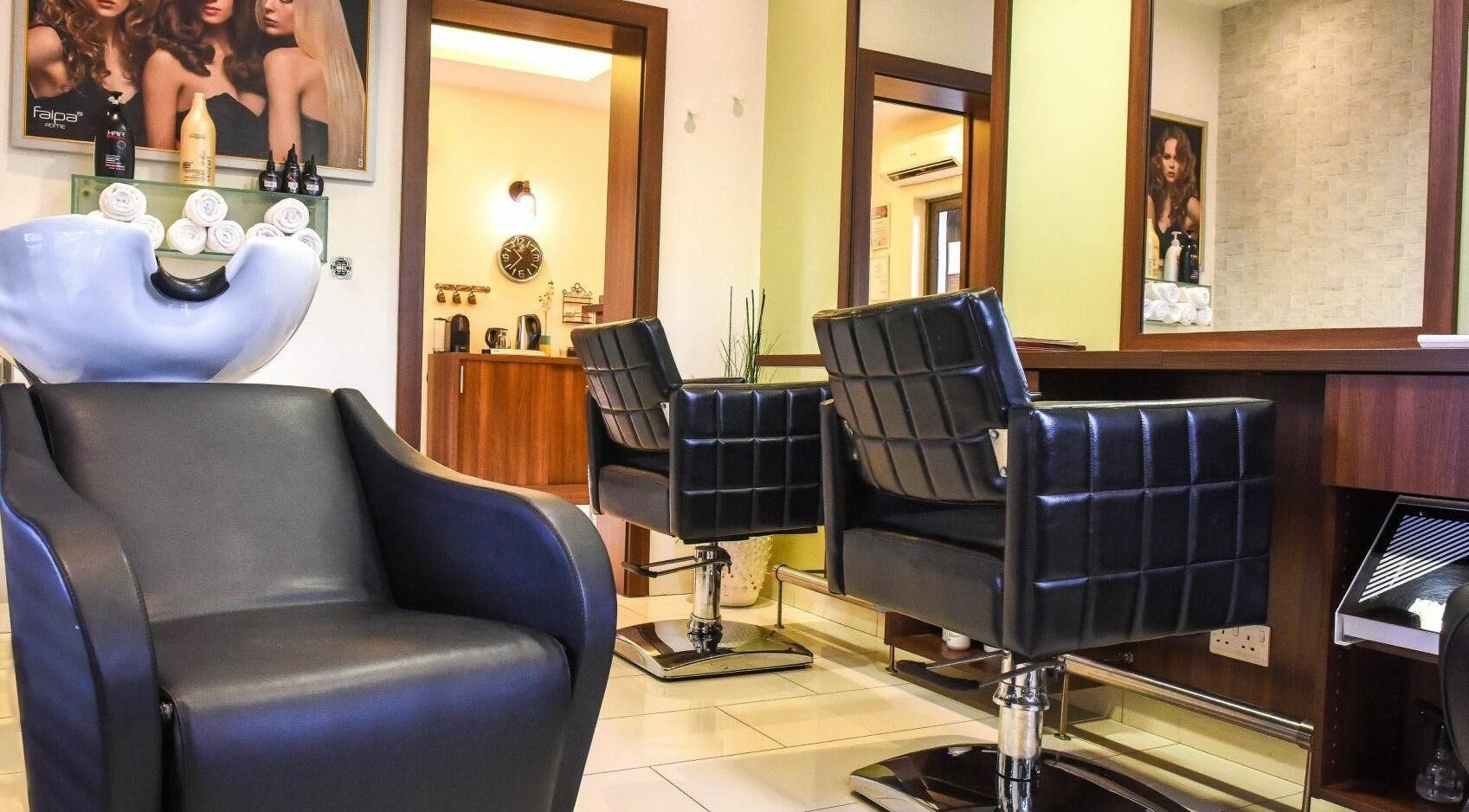 Modern salon interior at Beauty Addict, Abuja, Federal Capital Territory, NG, featuring stylish black chairs.