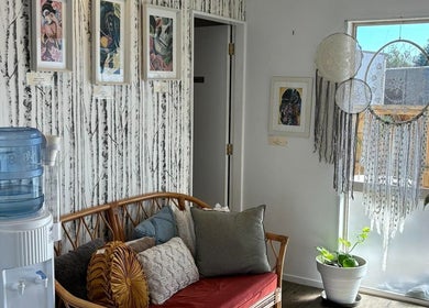 Relaxing corner at Trish Strike beauty in Tauranga, Bay of Plenty, NZ with rattan sofa and dreamcatchers.