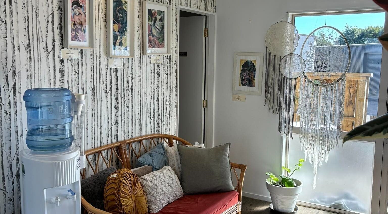 Relaxing corner at Trish Strike beauty in Tauranga, Bay of Plenty, NZ with rattan sofa and dreamcatchers.