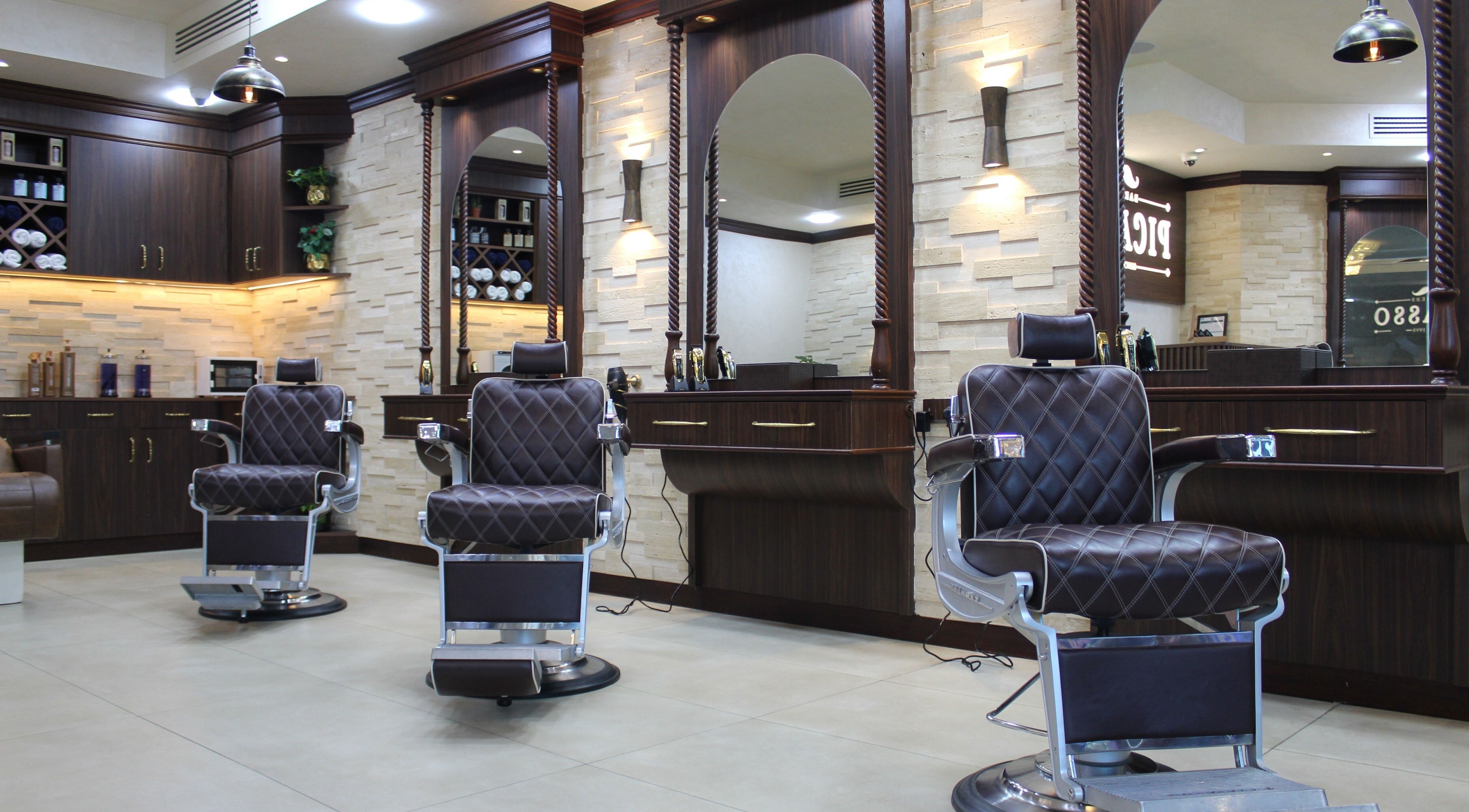 Elegant interior of Picasso Barbers in Dubai, AE with plush barber chairs and stylish decor.
