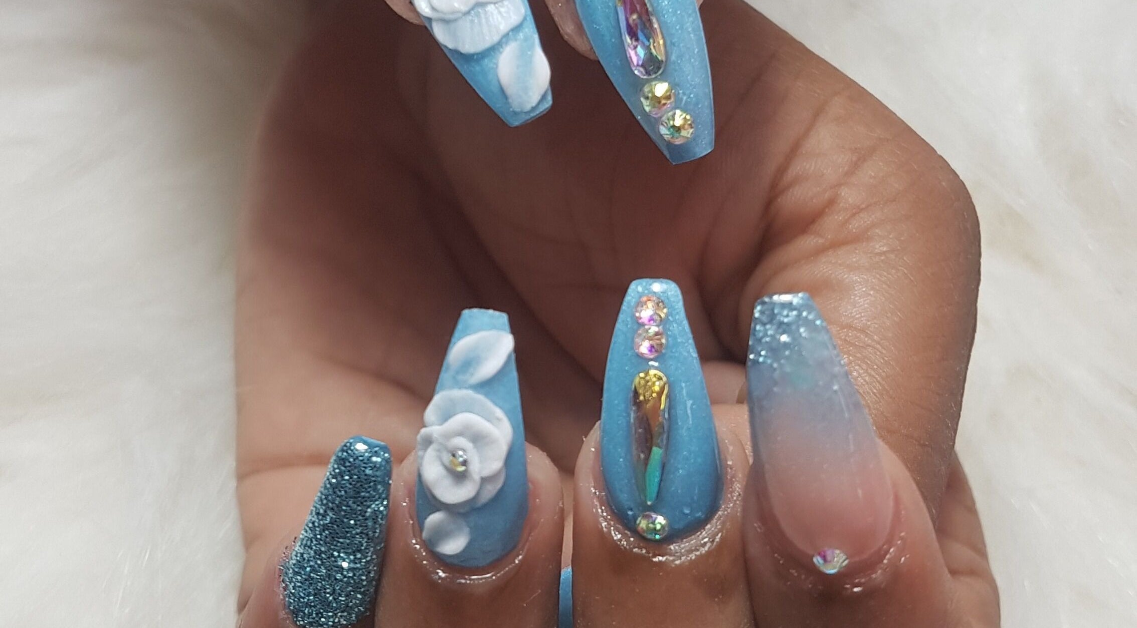 Stylish blue nail art with 3D flowers at Teaser's Nail Care, Bridgetown, Saint James, BB.