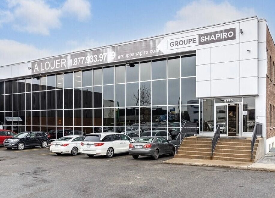 Façade du bâtiment Meraki Browz à Montréal, Québec, CA avec grandes fenêtres et parking.