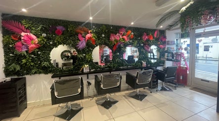 Lush floral decor enhances the serene salon atmosphere at Hair at O’Neills, Fareham, England, GB.