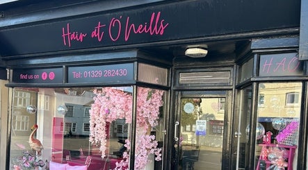Front of Hair at O’Neills salon in Fareham, England, showcasing its stylish exterior and vibrant decor.