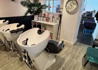 Elegant wash stations inside Hair at O’Neills salon in Fareham, England, GB with stylish decor.