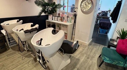 Elegant wash stations inside Hair at O’Neills salon in Fareham, England, GB with stylish decor.