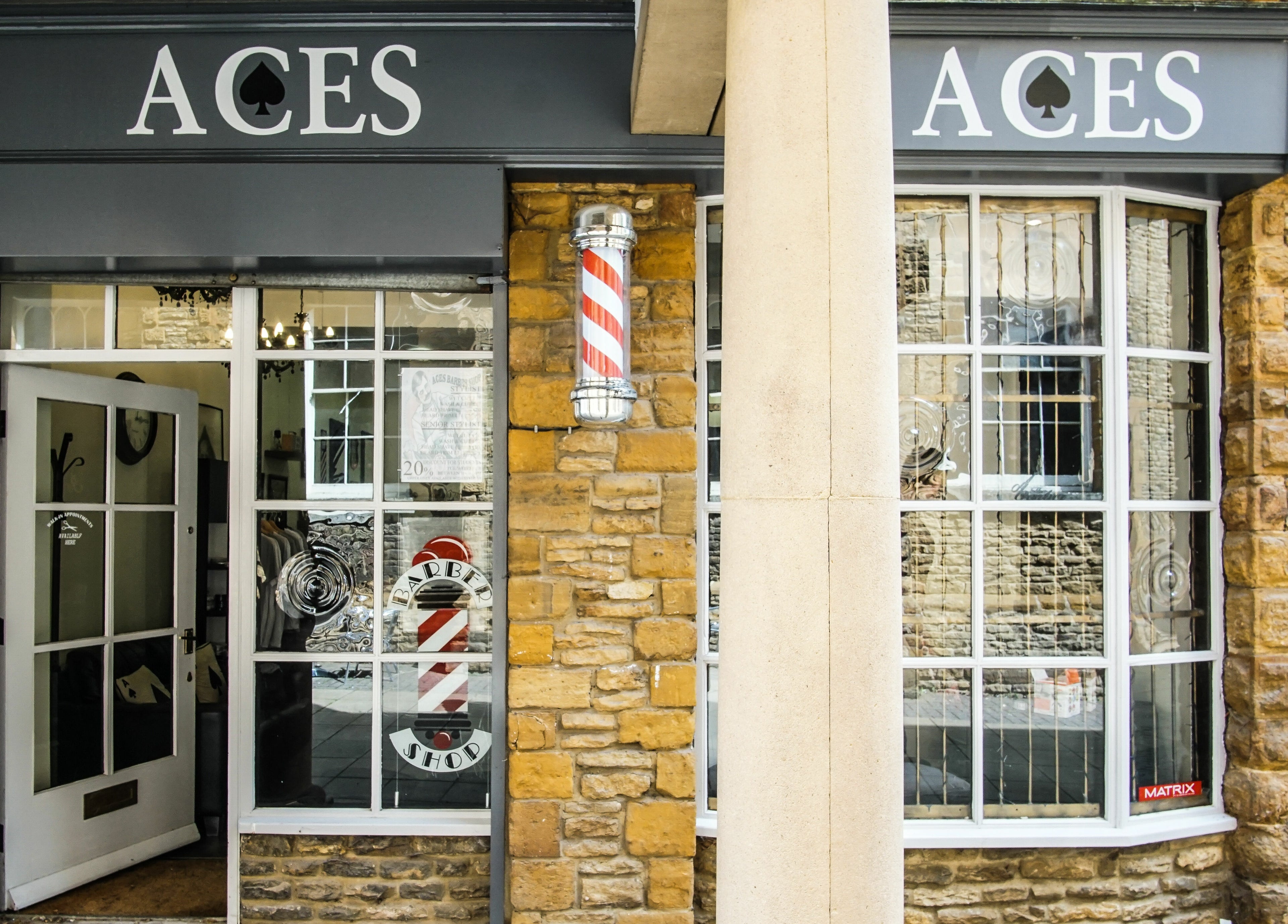 Entrance to Aces Barbershop, College St Mews, Northampton, showcasing its elegant exterior. Located in Northampton, England, GB.