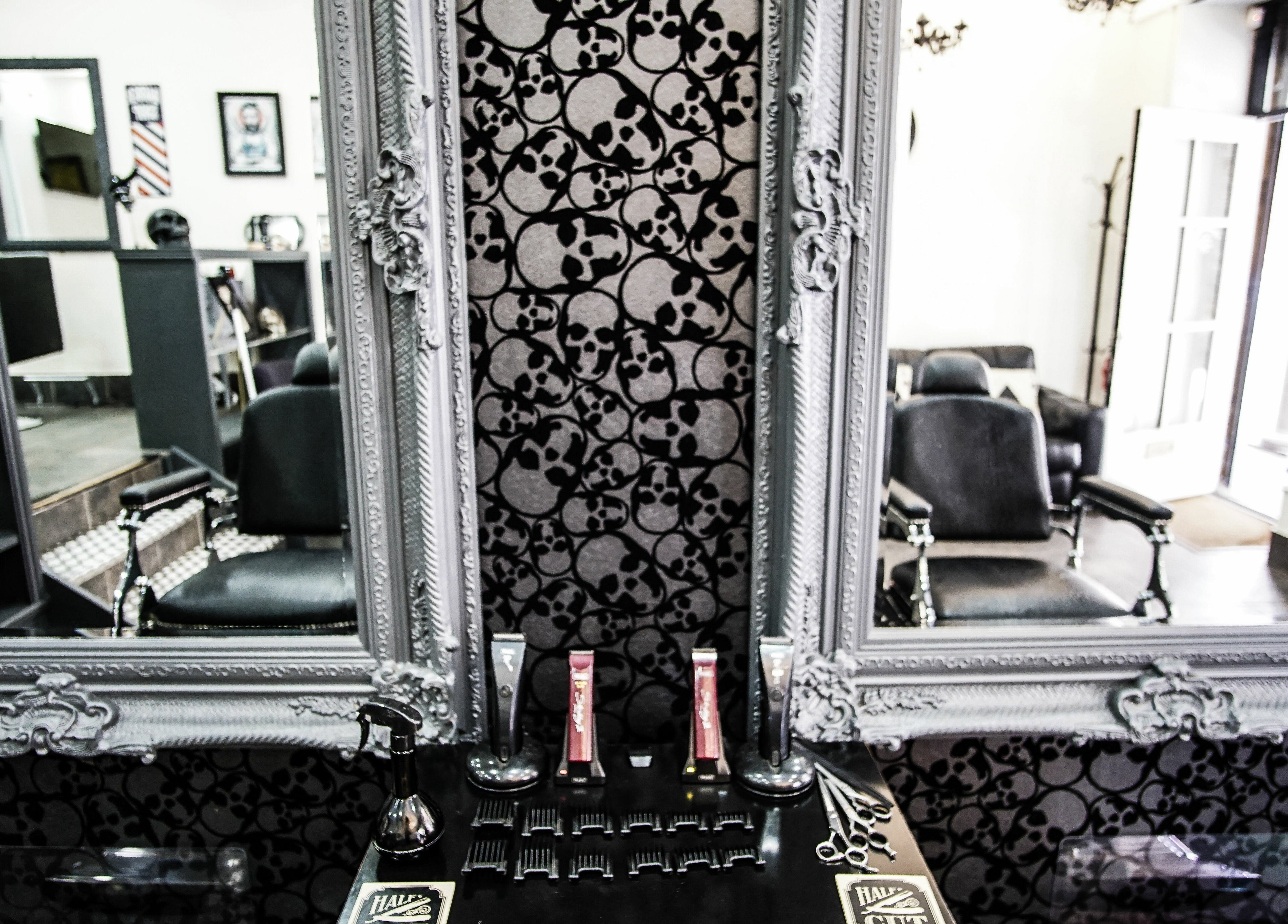 Elegant interior of Aces Barbershop with vintage mirrors, Northampton, England, GB. Reflects classic style.