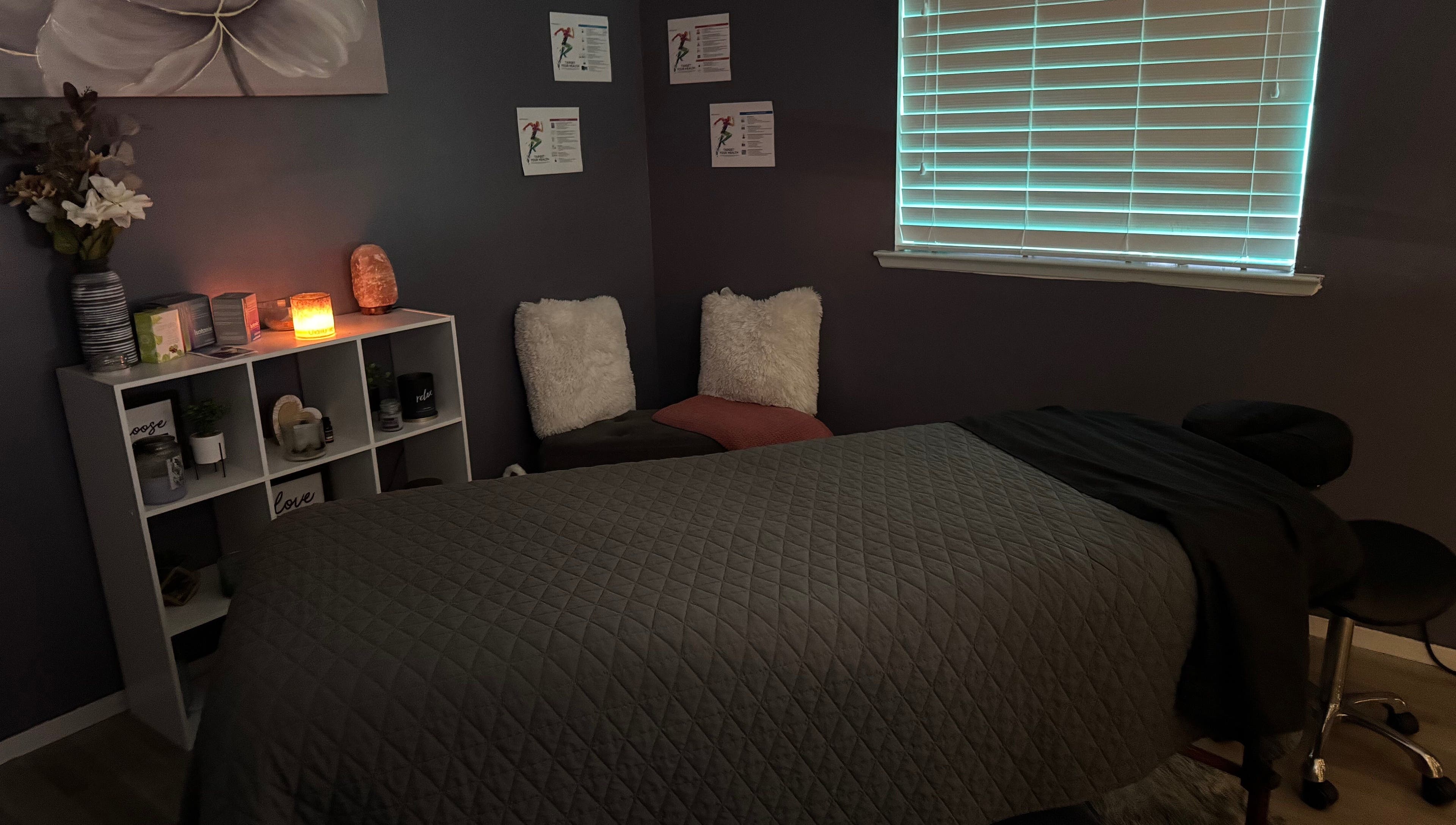 Cozy massage room at Hands on Healing, Coalinga, California, US, featuring soft lighting and serene décor.