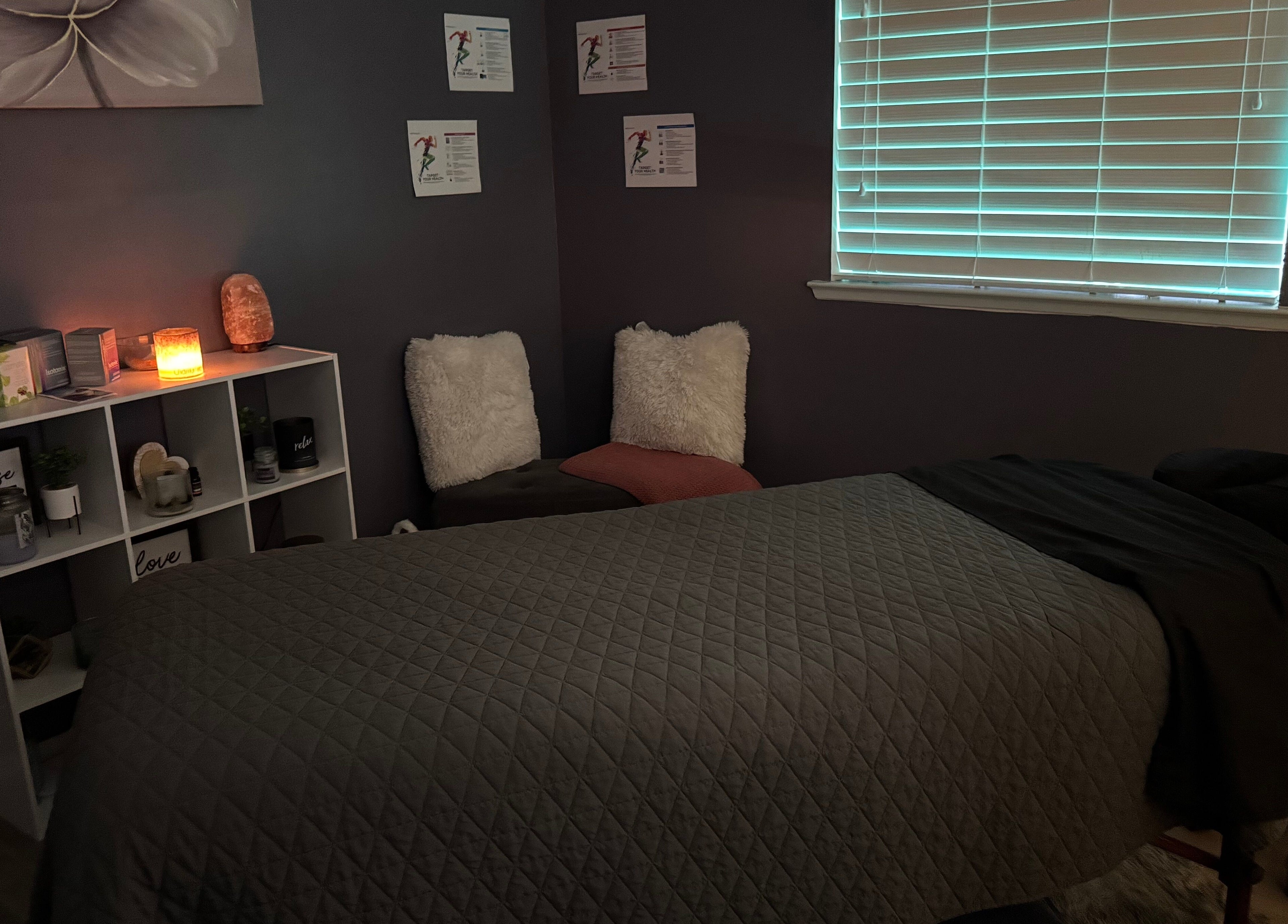 Cozy massage room at Hands on Healing, Coalinga, California, US, featuring soft lighting and serene décor.
