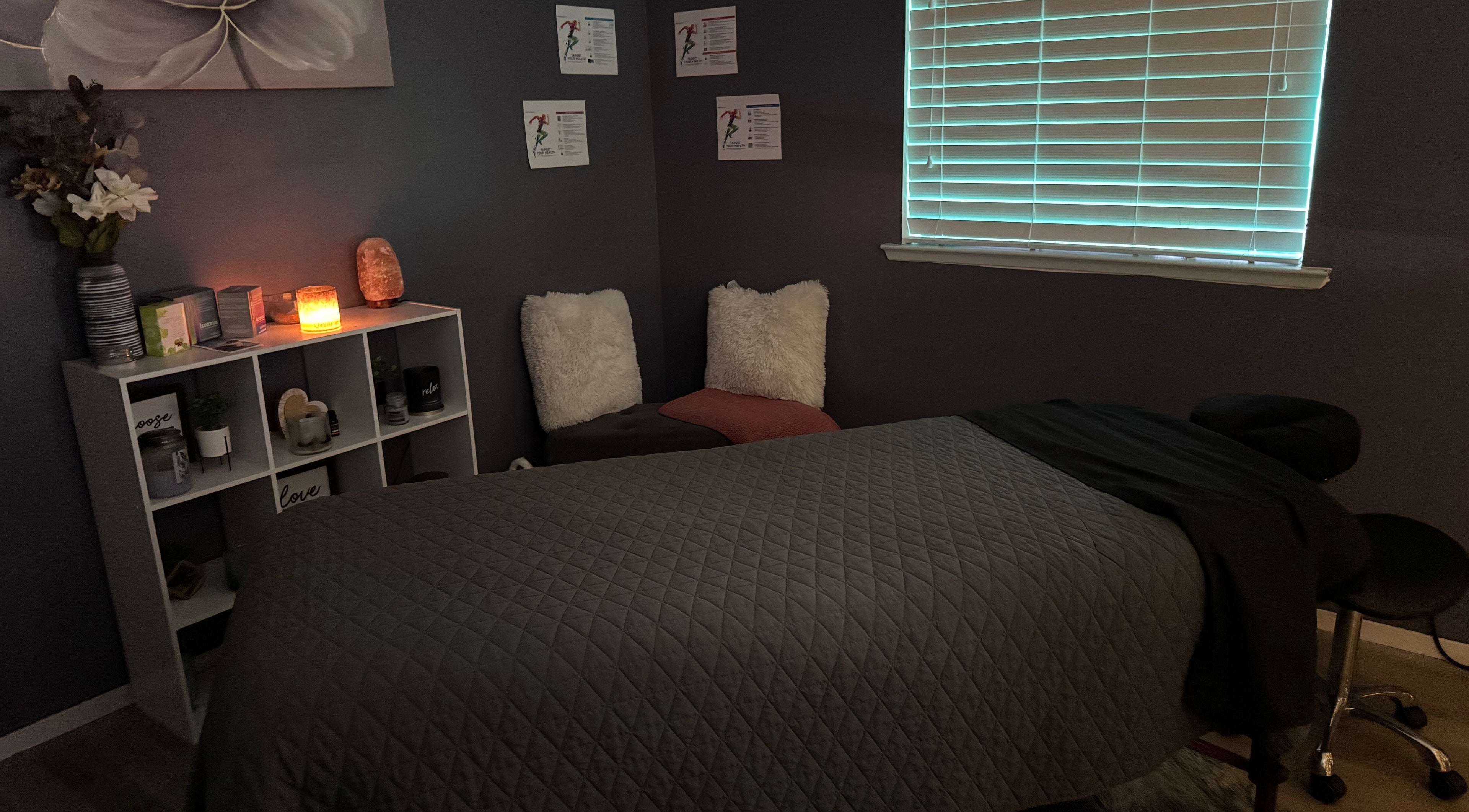Cozy massage room at Hands on Healing, Coalinga, California, US, featuring soft lighting and serene décor.
