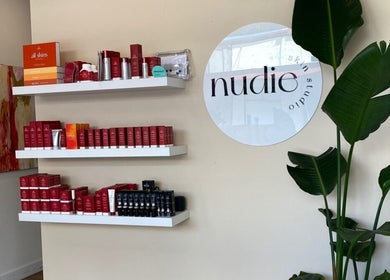 Product display at Nudie Skin Studio, Melbourne, Victoria, AU, featuring skincare on sleek white shelves.