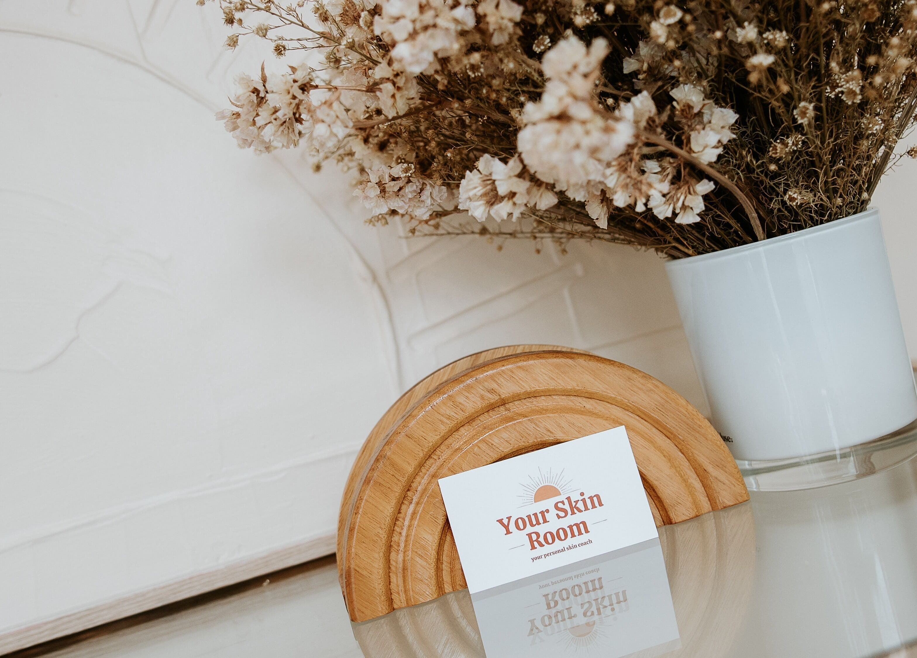 Your Skin Room card on stylish table with vase, Melbourne, Victoria, AU.