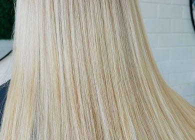 Smooth blonde hair styled at Tathra HairStudio, Tathra, New South Wales, AU with sleek, straight finish.
