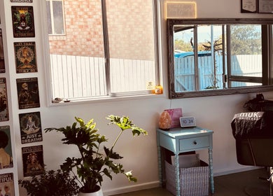 Stylish interior of Tathra HairStudio in Tathra, New South Wales, AU with plants and motivational posters.