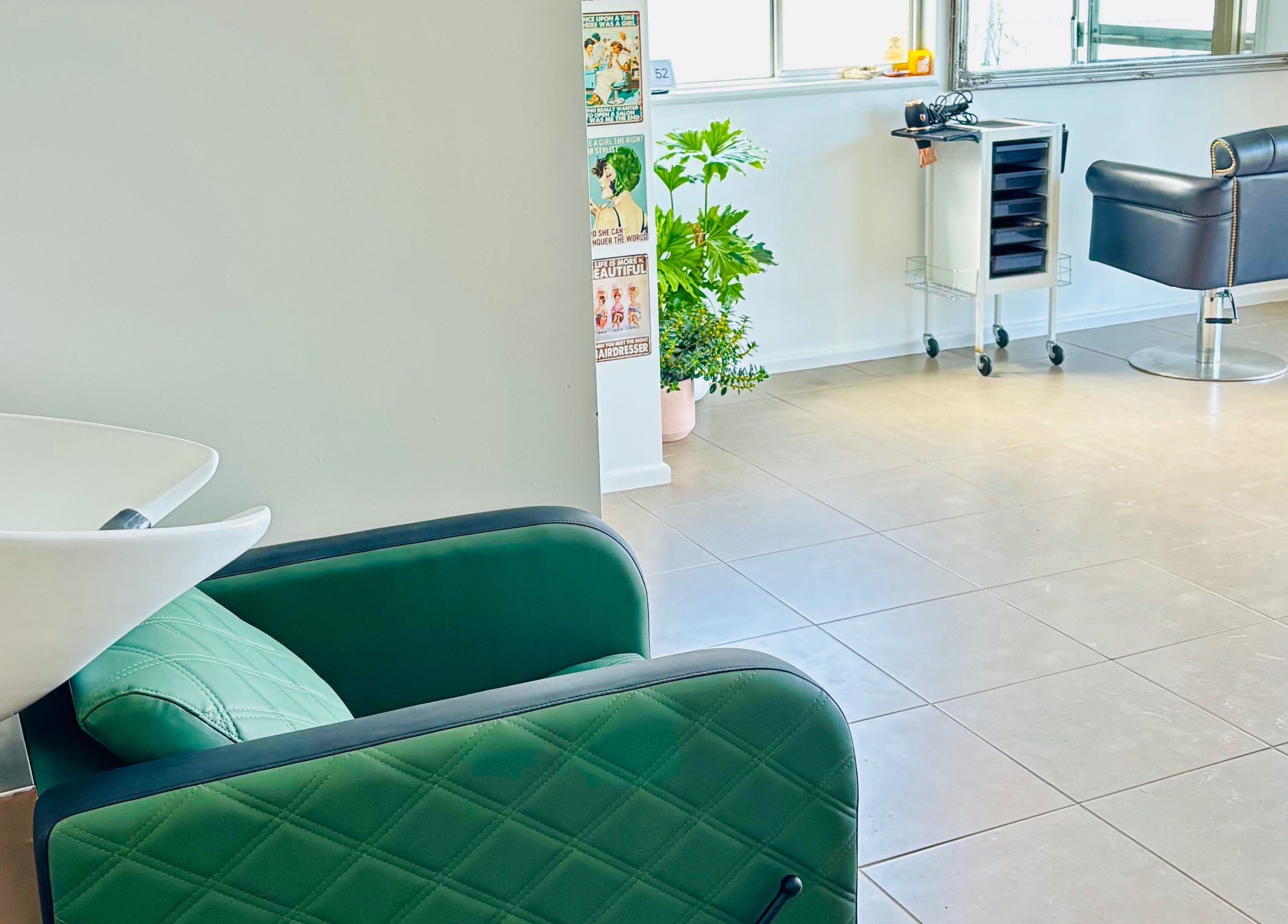 Chic interior of Tathra Hair Studio, Tathra, New South Wales, AU with modern chairs and wash station.