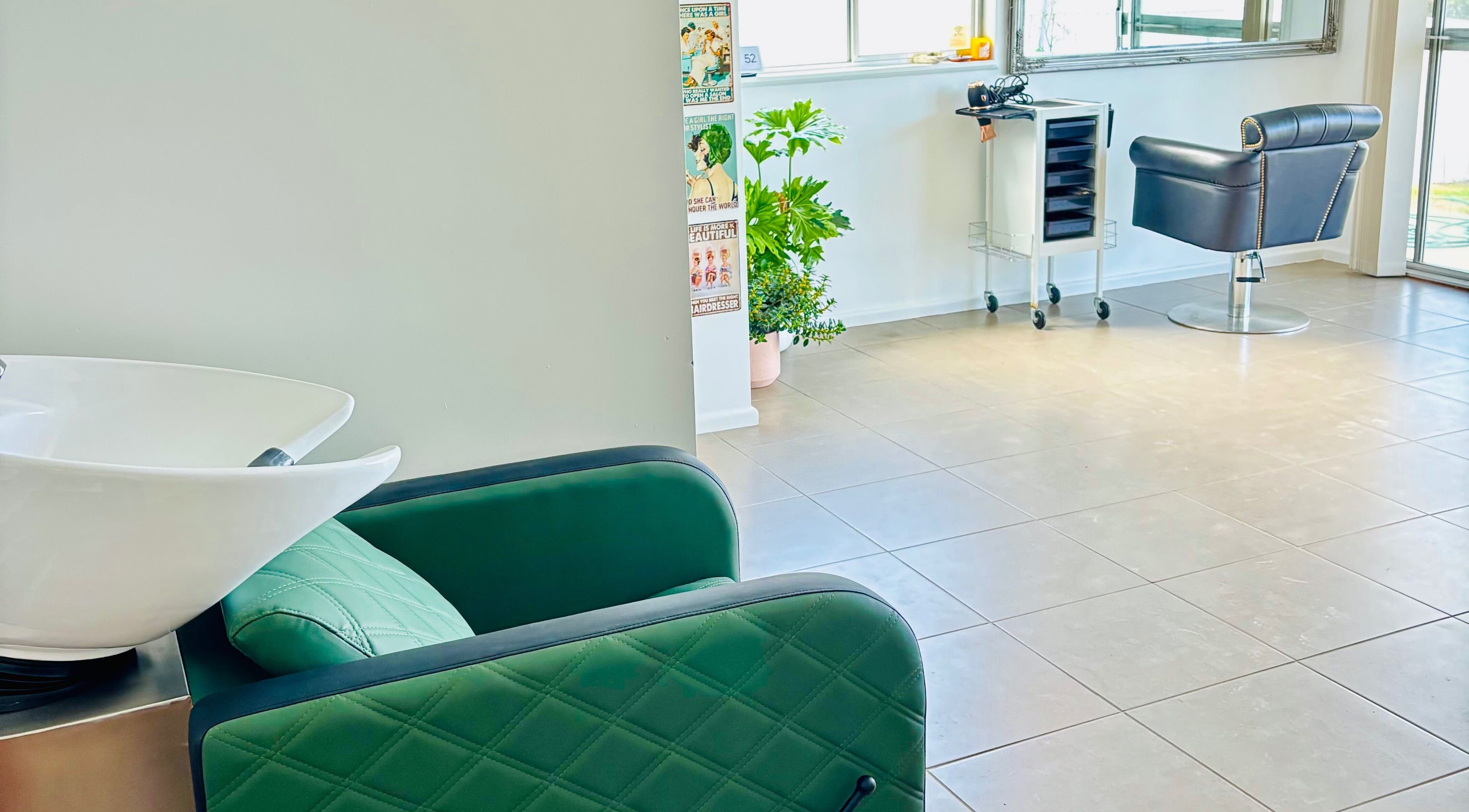 Chic interior of Tathra Hair Studio, Tathra, New South Wales, AU with modern chairs and wash station.