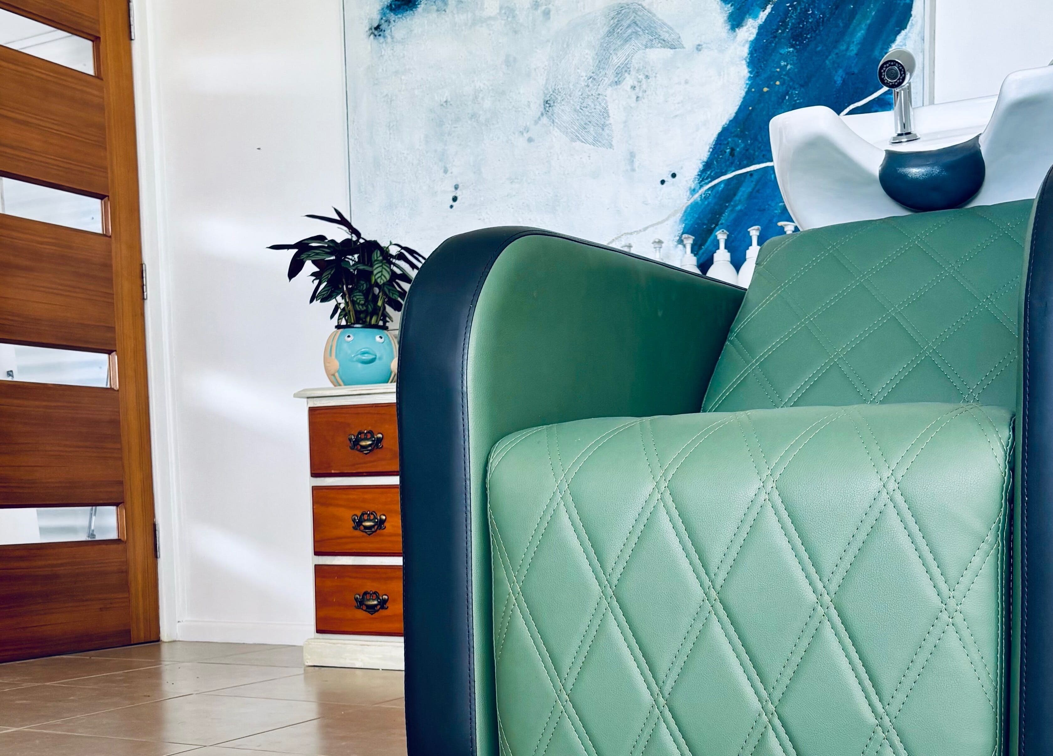 Luxurious green salon chair at Tathra Hair Studio, Tathra, New South Wales, AU, offering a relaxing experience.