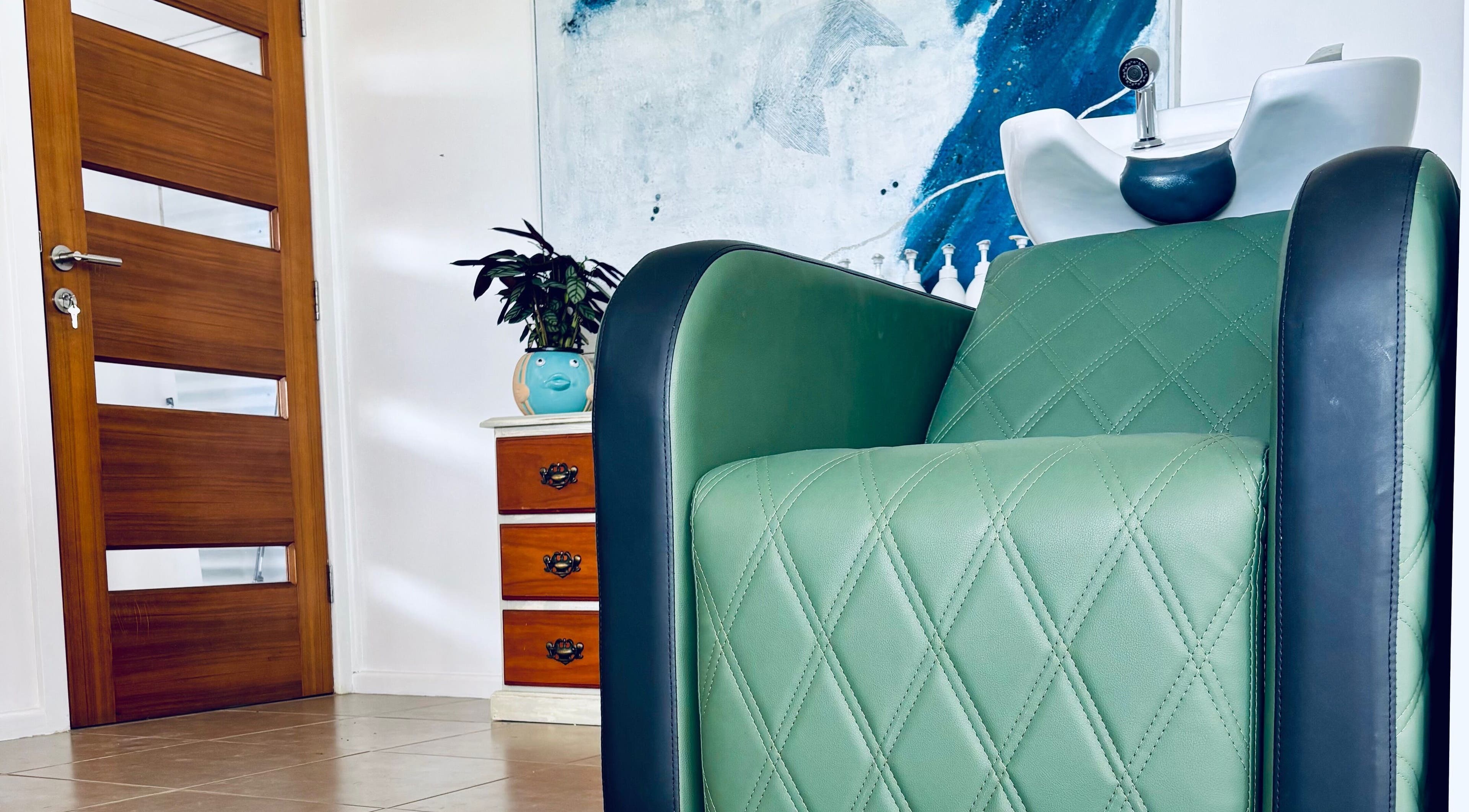 Luxurious green salon chair at Tathra Hair Studio, Tathra, New South Wales, AU, offering a relaxing experience.