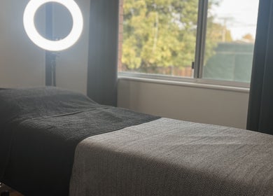 Cozy treatment room at Beauty Bar 11, Flinders View, Queensland, AU with a massage table and warm lighting.